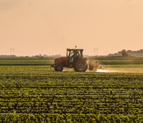 Farmer spraying soybean crops