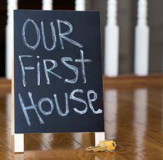 Our first house sign with keys showing couples first adventure into buying a new home